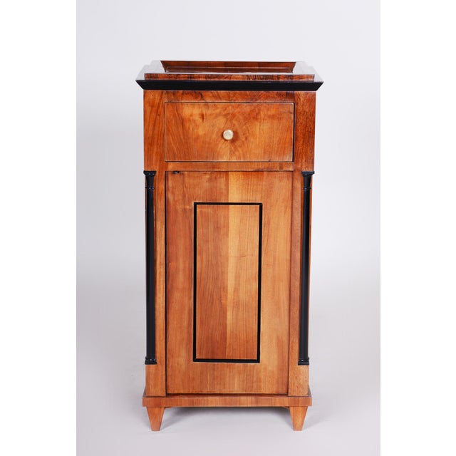This nightstand is a beautiful and authentic example of Biedermeier furniture art from the first half of the 19th century,...