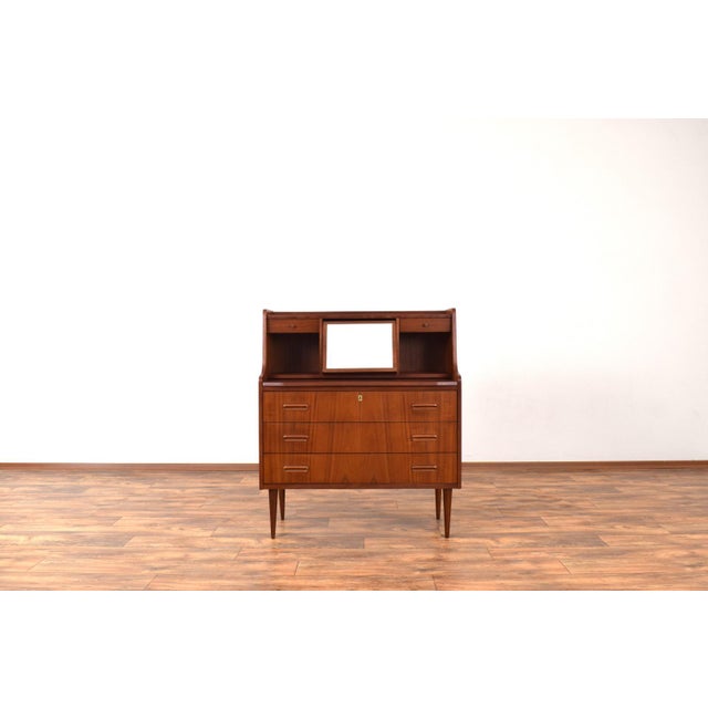 This high-quality teak secretary was manufactured in Denmark in the 1960s. The furniture has been professionally and...