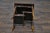 An English bamboo and woven rattan side table from circa 1920 with sectioned shelves. This charming English side table...