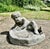 A well Weathered Garden Bird Bath with a Small Child lying on his side Playing in the Water, a lovely piece which holds a...
