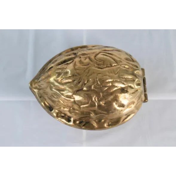 Heavy brass walnut shaped nut cracker. Can be used as a display piece, ring dish or paperweight as well. Patina present.