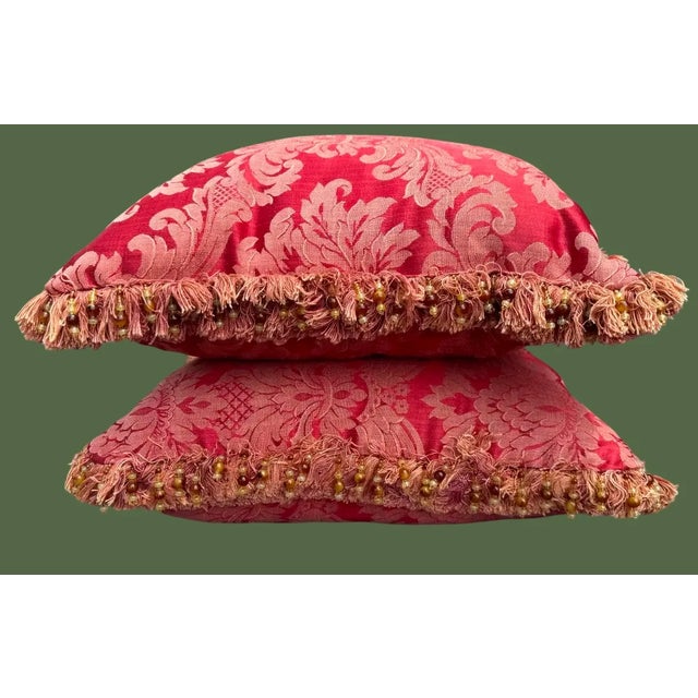 Custom made pair of red damask pillows with beaded fringe. Measures 17”x17”, down filled.