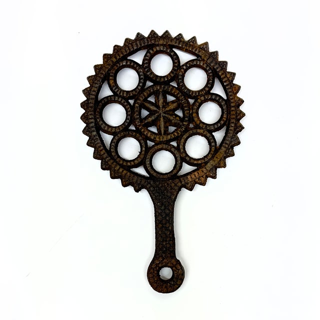 Cast Iron decorative trivet curation, group of 7. This is a rustic set of cast iron decorative trivets featuring a variety...