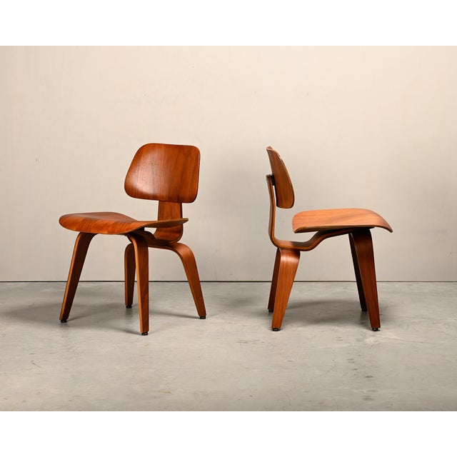 Iconic pair DCW dining side chair in Walnut plywood. Early Herman Miller production from the fifties (5-2-5 screw...