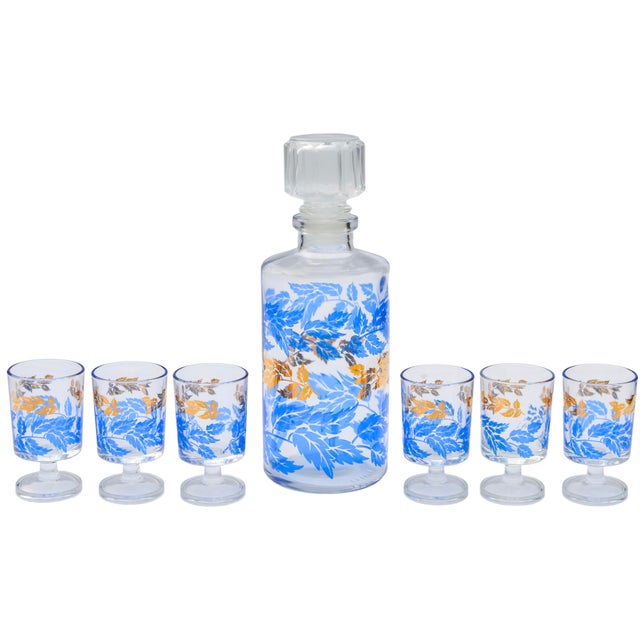 Stunning set of seven midcentury handblown glasses and matching decanter with stopper. Exhibiting an elaborate hand-...