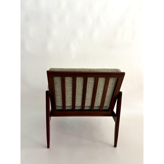 An elegant pair of "candidate" armchairs designed by ibkofod-larsen and crafted from solid afrormosia (african teak) for...