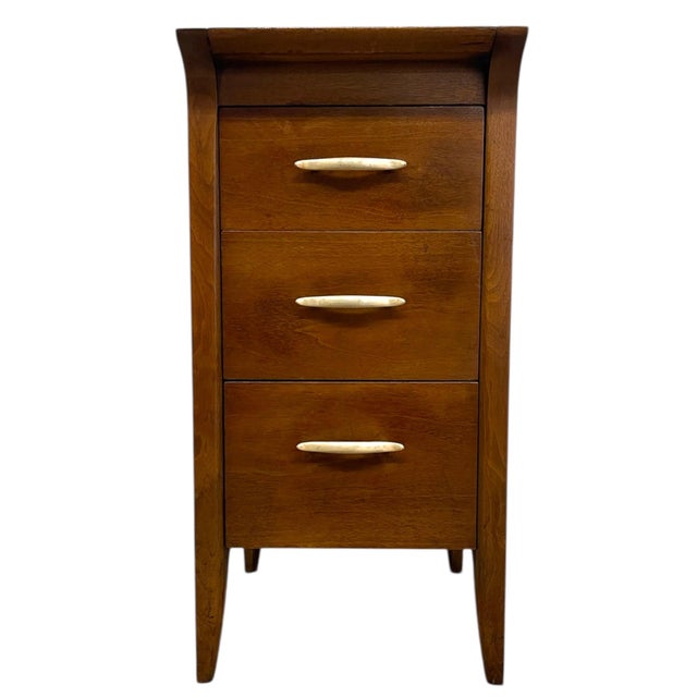 This mid-century modern three-drawer nightstand by Drexel features clean lines, warm wood tones, and the brand's signature...