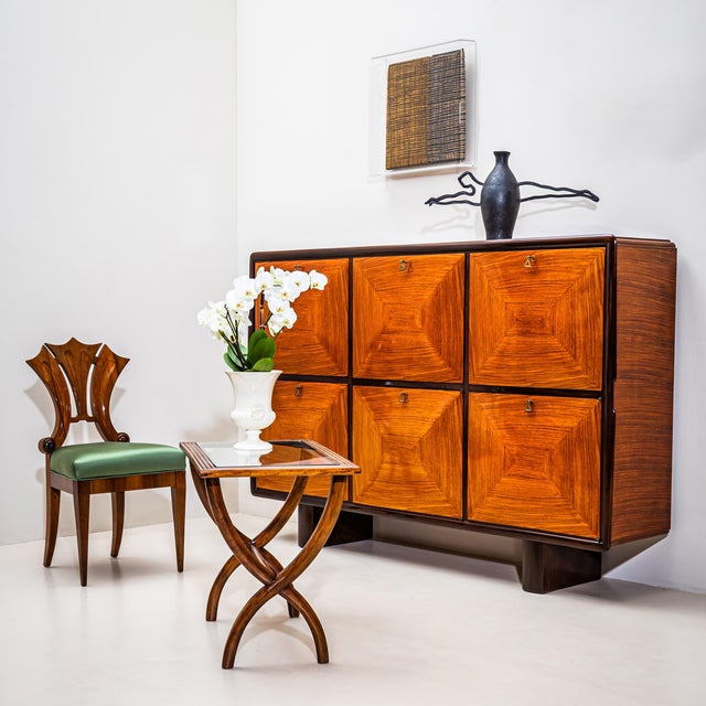 Large Italian Mid-Century high board with six doors and keys featuring characteristic triangular decorative handles. The...