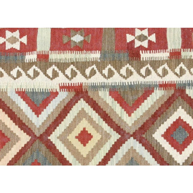 This 6'3" x 9'9" Vintage Afghan Maimana Kilim is hand-woven by the Maimana tribes of Northern Afghanistan using wool on a...