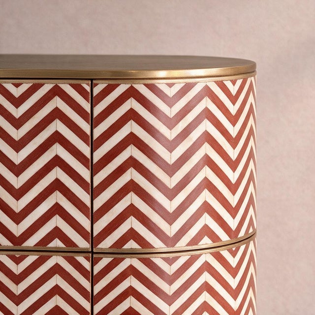 The Veyra Chevron Bone Inlay Six-Drawer Dresser presents a bold interpretation of geometric ornament, combining the visual...