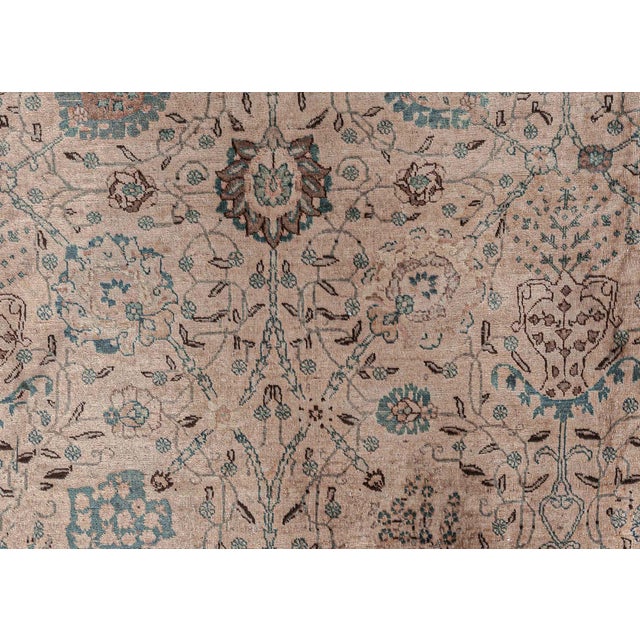 This circa-1920 antique Tabriz Persian rug features a strikingly elegant all-over design of floral abstractions,...