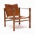 A handsome mid-century safari-style armchair combining a warm wood frame with beautifully aged cognac leather. The chair...