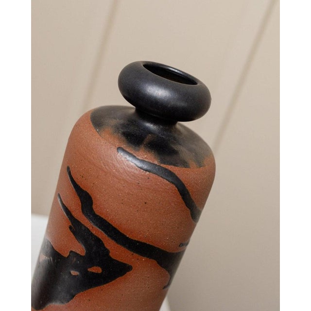 This vintage set of carafe (or vase) and drinking cup (or vase) is a studio ceramic by Tristan Drechsler from the 1970s....