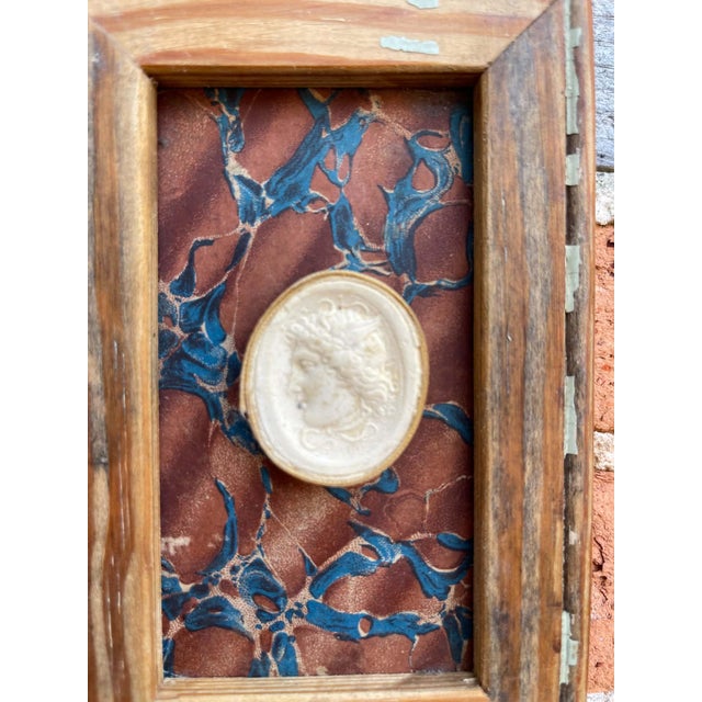 Immerse yourself in the enduring allure of classical antiquity with this truly unique collection of framed intaglios....