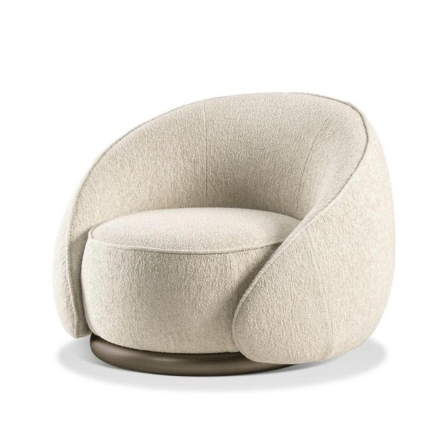 A softly enveloping silhouette defines this beige armchair by Lorenza Bozzoli, designed to suggest an intimate embrace...