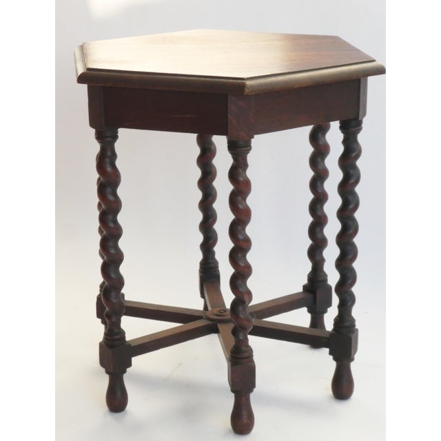 An amazing antique wooden side table with an hexagonal top. The side table is standing on 6 barely twist legs. Rare to...
