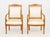 Pair of French Empire Style Walnut Arm Chairs, with scroll form crest and white silk upholstery on four scroll form legs....
