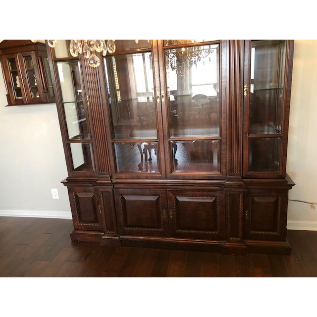 1990's Large lighted china cabinet in rich mahogany. 2 pieces. Nice statement piece. This item was purchased from Star...