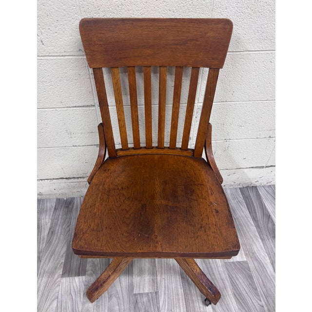 This is a beautiful antique Arts & Crafts Mission-style oak swivel desk chair, circa 1900–1920, featuring striking...