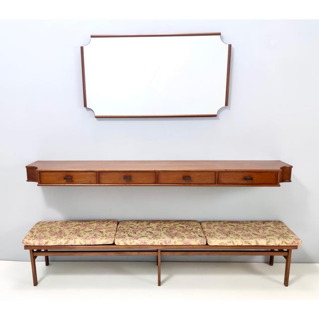 Made in Italy, 1959. The console table are made in walnut. The design of the corners of the mirror recalls that of the...