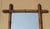A charming antique English decorative wall mirror, featuring a beautifully turned faux bamboo wooden frame and aged foxed...