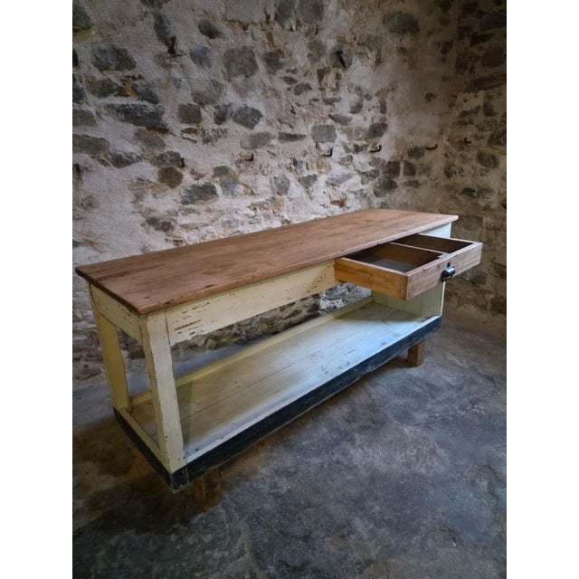 This vintage French worktable dates from approximately the 1930s and was originally used as a fabric shop table. Made of...