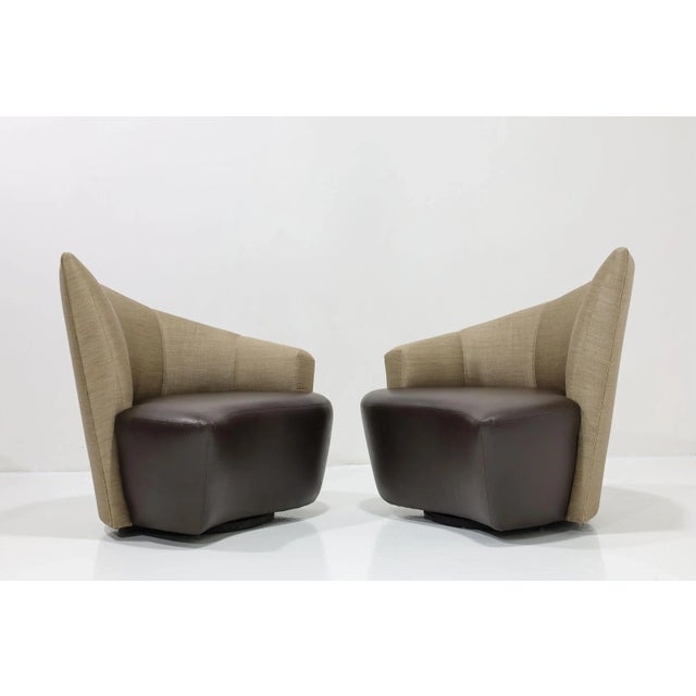 A Post Modern pair of Vladimir Kagan Bilbao swivel chairs upholstered in silk and leather circa 1990s. Enamored with...