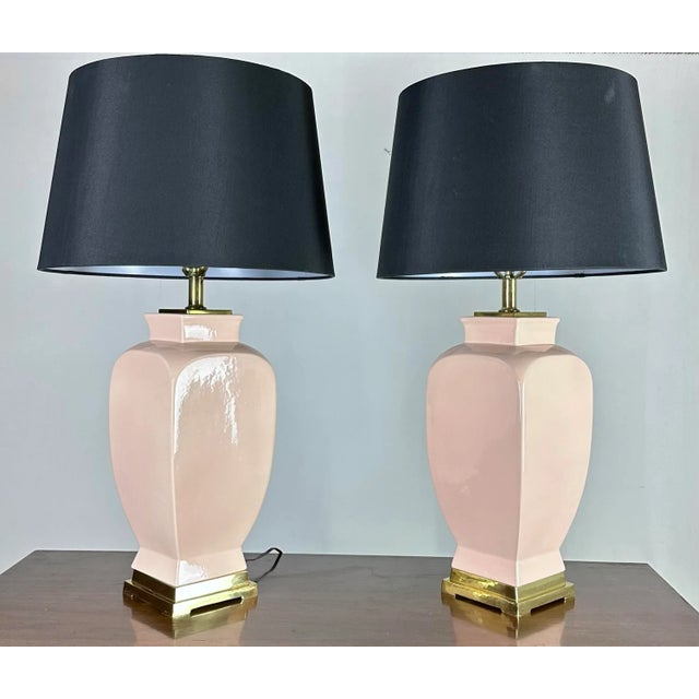 A stylish pair of deco moderne ceramic and brass table lamps in a subtle muted antique pink/coral shade. The color works...