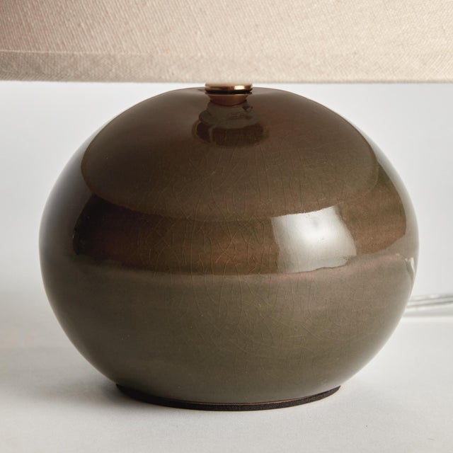 With a blue crackle glazed body and light linen shade, this lamp is a handsome fixture. At just around 10 inches tall, it,...