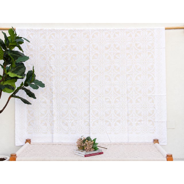 A lightweight cotton coverlet from Western India, beautifully adorned with intricate handcrafted appliqué cutwork. The...