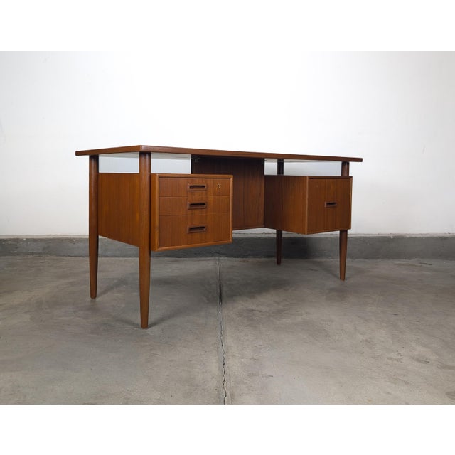 An iconic example of Danish mid-century modern design, this floating top executive desk was Attributed to Johannes Sorth...