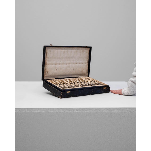 Set of twelve 19th Century French silver-plated forks presented in their original fitted case. Each fork showcases elegant...