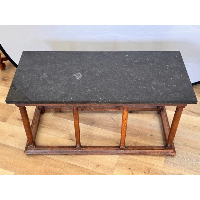 A Baroque Walnut and Marble Low Table, 17th Century. The later rectangular black marble top, especially beautiful with...