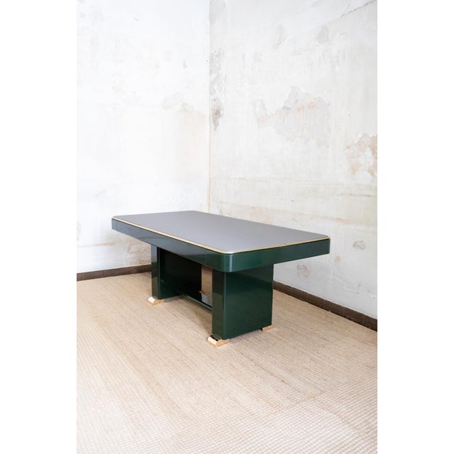 Green Lacquered Console with Leather Top And Brass Details – 1970s Glossy green lacquered structure with a grey leather...