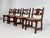 1950s Design Oak Wooden And Braided Straw Seats Set of 4 Chairs composed of a brutalist wooden structure adorned with a...