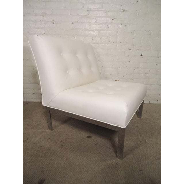 Sleek and sturdy side chairs with polished chrome base, newly recovered in a tufted white Naugahyde. Simple and handsome...