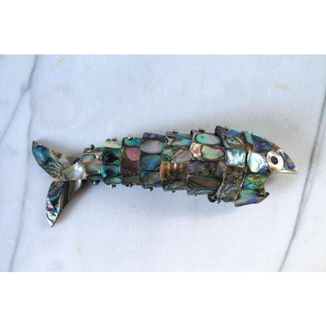Vintage articulated fish bottle opener, handmade of abalone shell. No makers mark. Minor age wear.