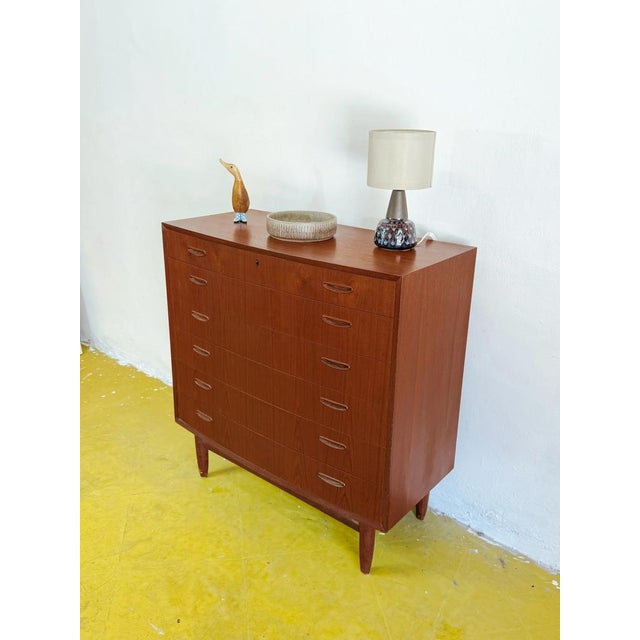 Vintage Danish teak horizontal chest of drawers from the 1950s with six rows of drawers. Its spacious design, recessed...