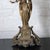 Bronze church altar candelabra with angel and floral motif.