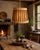 Tapered drum-shaped pendant built from a combination of natural, handcrafted materials. Its structure is defined by...