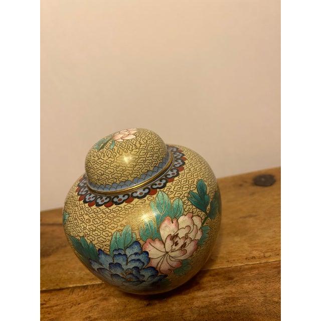 Lovely ginger jar in a subtle shade of mustard with blue, green, pink, red, blue and gray. There are many variations in...