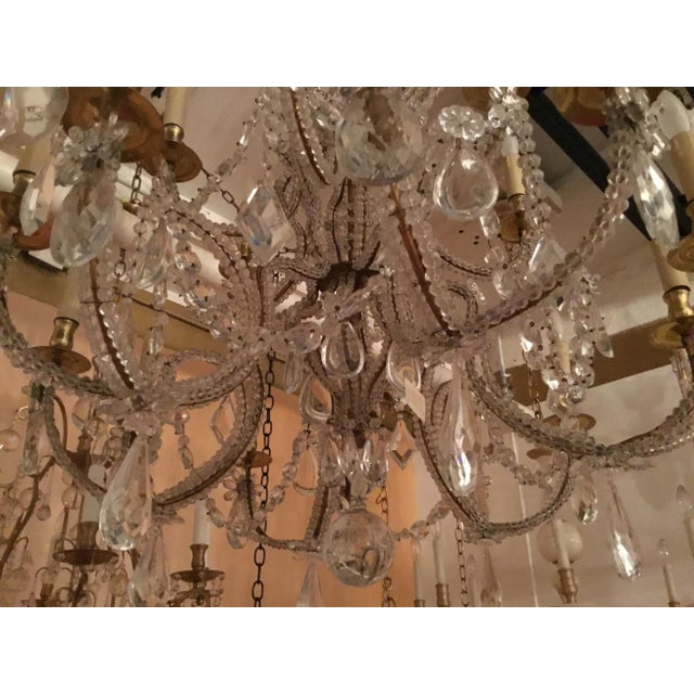Mid 1970’s Bagues chandelier……18 lights, 2 tiers 33” diameter, 48” long. Most classic Bagues style. Gilded iron. Gilding...