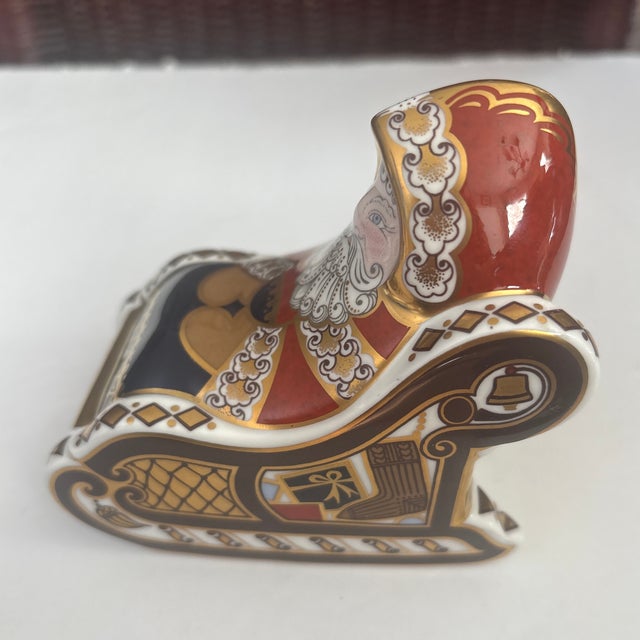 ROYAL CROWN DERBY SANTA & SLEIGH PAPERWEIGHT. It measures approximately 4" in height. It features magnificent coloring and...