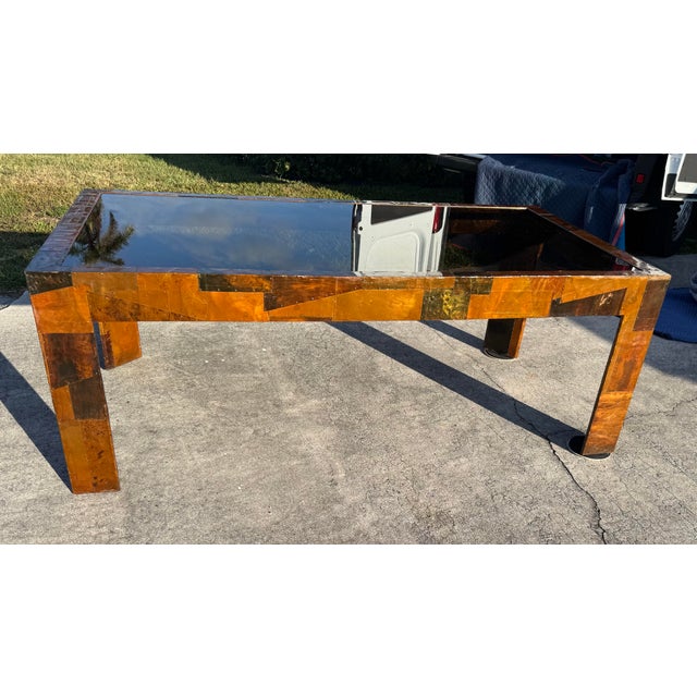 This sculptural table features a bold geometric patchwork of mixed metals with rich natural patina, showcasing Evans-style...