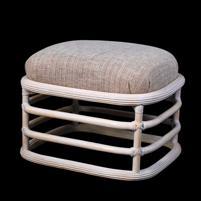 A pair of low stools wrapped in blonde pencil reed, the fine vertical reeds giving each piece a tailored, sun-washed...