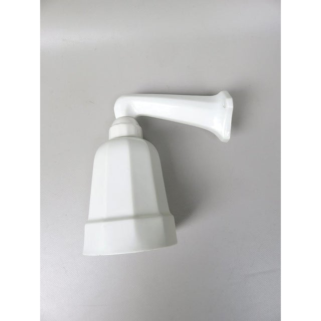 A petite wall lamp from the time of Art Deco, made in France. It is perfectly suitable for attaching it over a mirror. It...