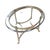Elegant vintage oval coffee table featuring a substantial beveled glass top supported by a sculptural brass base. The...