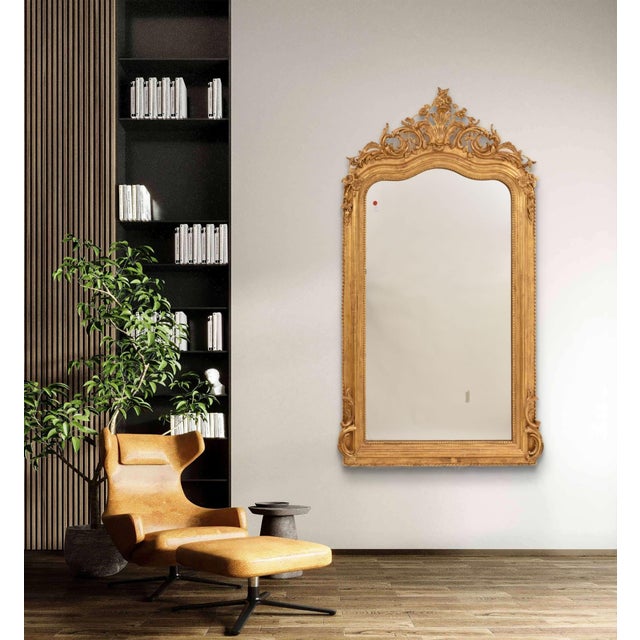 The elegant Antique Gilt Mirror with Floral Crest and Scrolls presented here dates back to the mid-19th century and...