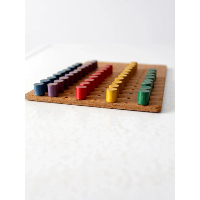 This is a vintage peg board toy circa mid 20th century. The toy set includes two boards with red, purple, green, yellow,...