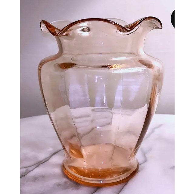 Gorgeous, hand blown, pink glass vase. Elegant design in a beautiful pink hue. It is such a pretty piece that it can be...